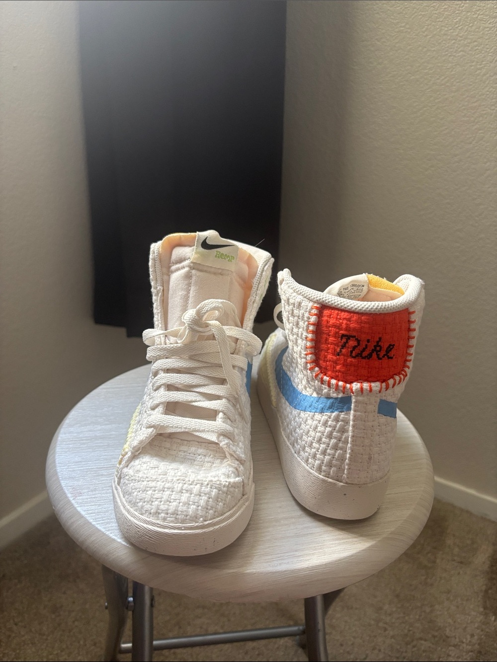 Nike White High-Top Sneakers with Blue Swoosh and Orange Heel Patch